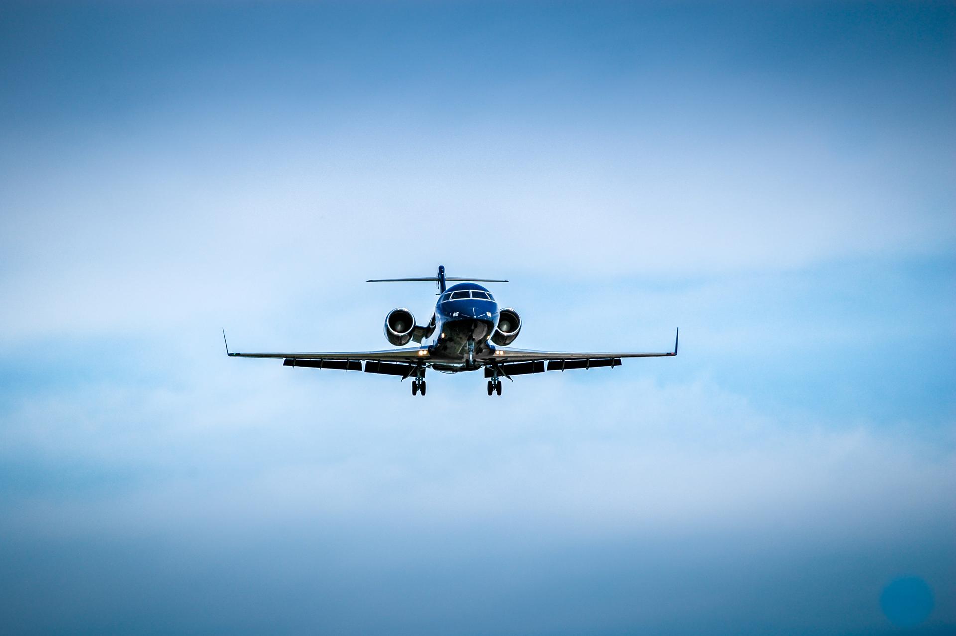 Luxurious black jet coming in for landing.