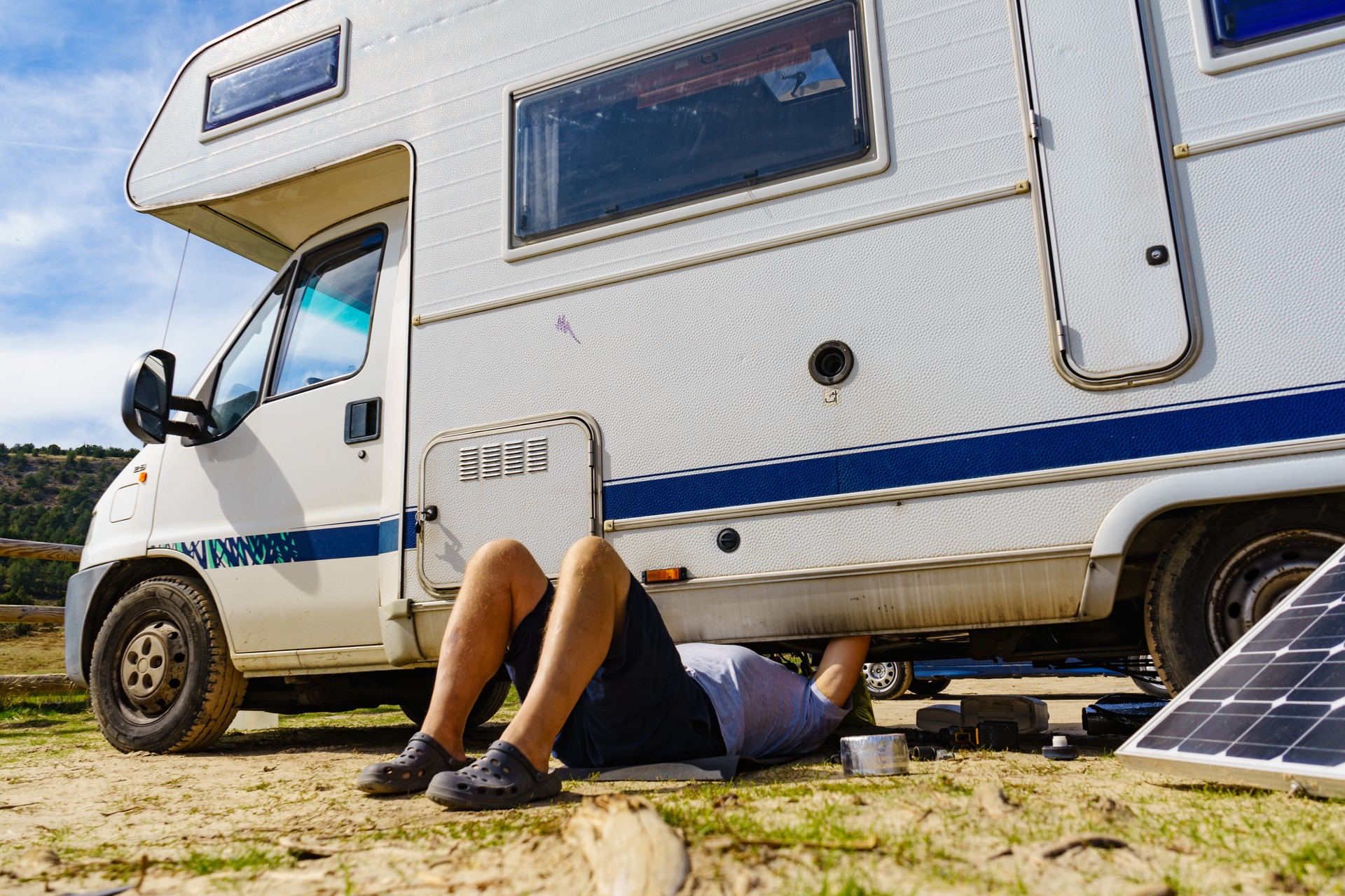 Man repairing bottom of the rv caravan